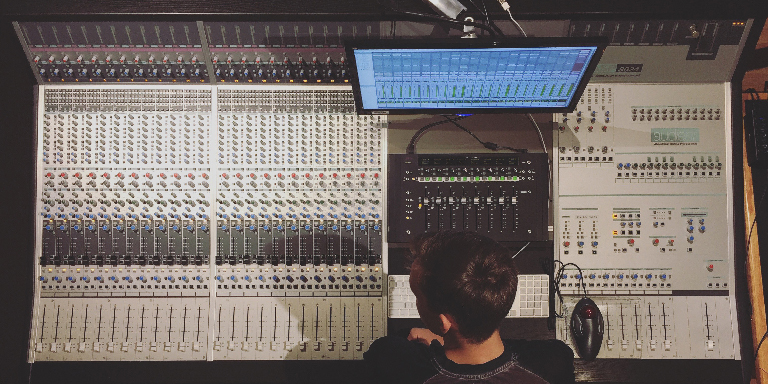 Student working at a mixing console