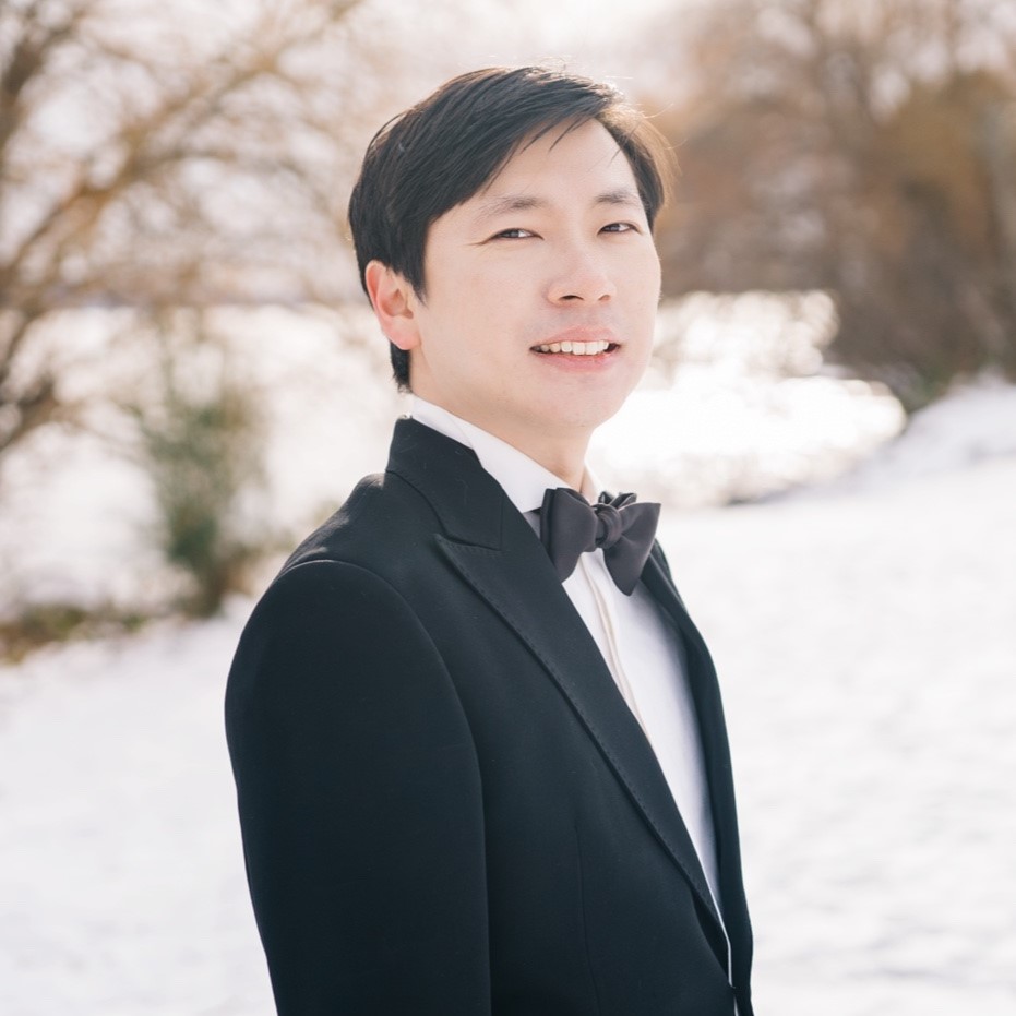 Man wearing a tuxedo, outside with a snowy background