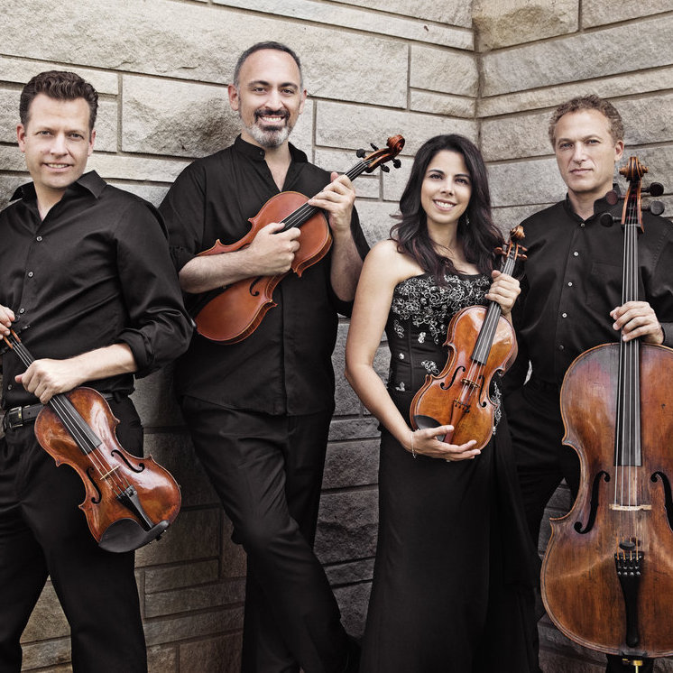 The Pacifica Quartet holding their instruments.