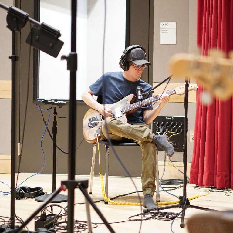 Student playing guitar in the Georgina Joshi studio