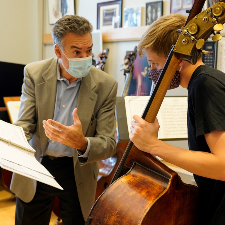 Jeffrey Turner, professor of double bass, teaches a student in his studio at Jacobs.
