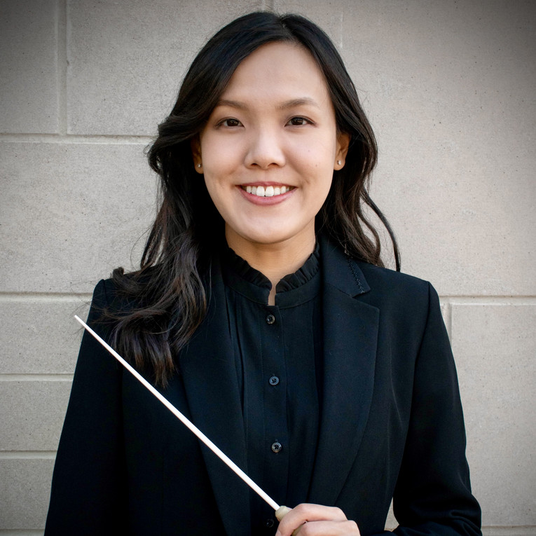Woman smiling holding a baton