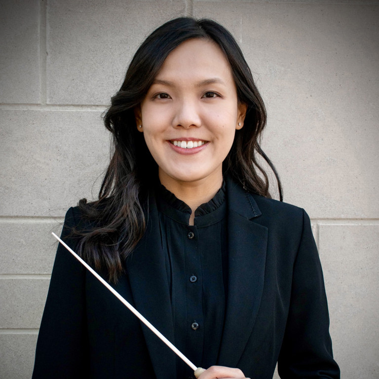 Woman smiling holding a baton