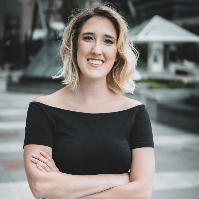 Woman smiling with her arms crossed